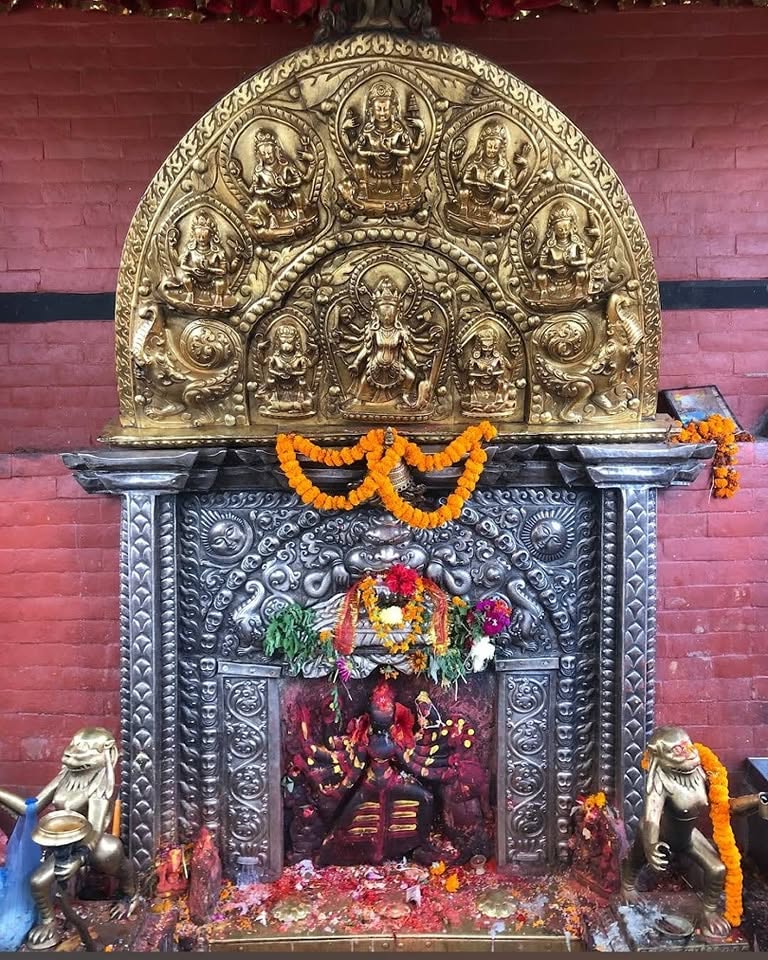 The shrine of Sobha Bhagavati at Nirmal Tirtha, Kathmandu, with its guardian lions and rows of lamps