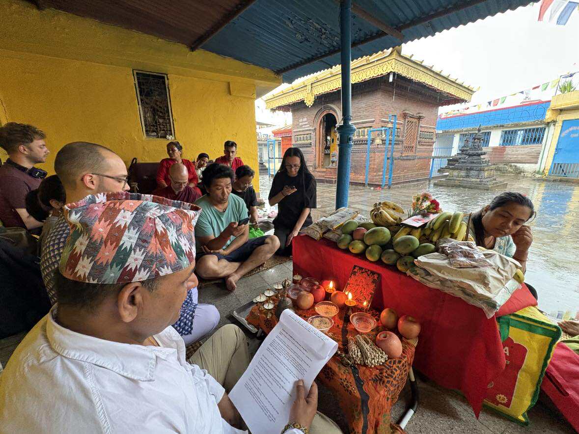 Participants gathered for monthly Vasudhara puja with traditional offerings